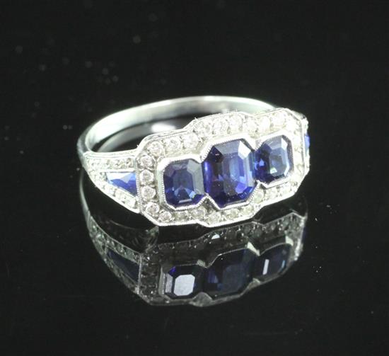 A white gold three stone sapphire and diamond cluster ring, size M.